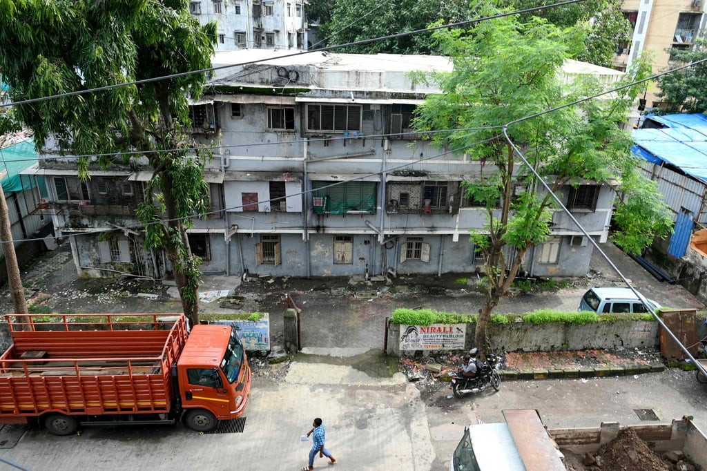 Dilapidated Mumbai buildings endanger lives as residents defy high rents, face demolition, and grapple with worsening climate conditions. Photo: AFP