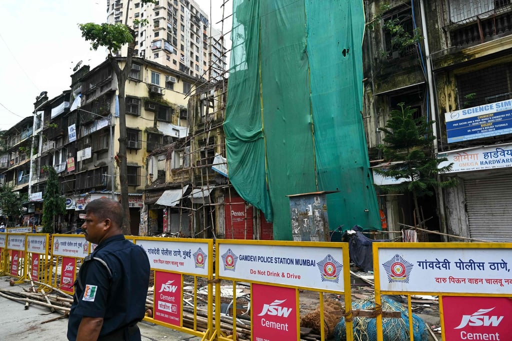 A security guard stands outside the Rubbunnisa Manzil building, partially collapsed after monsoon rains in Mumbai. Photo: AFP