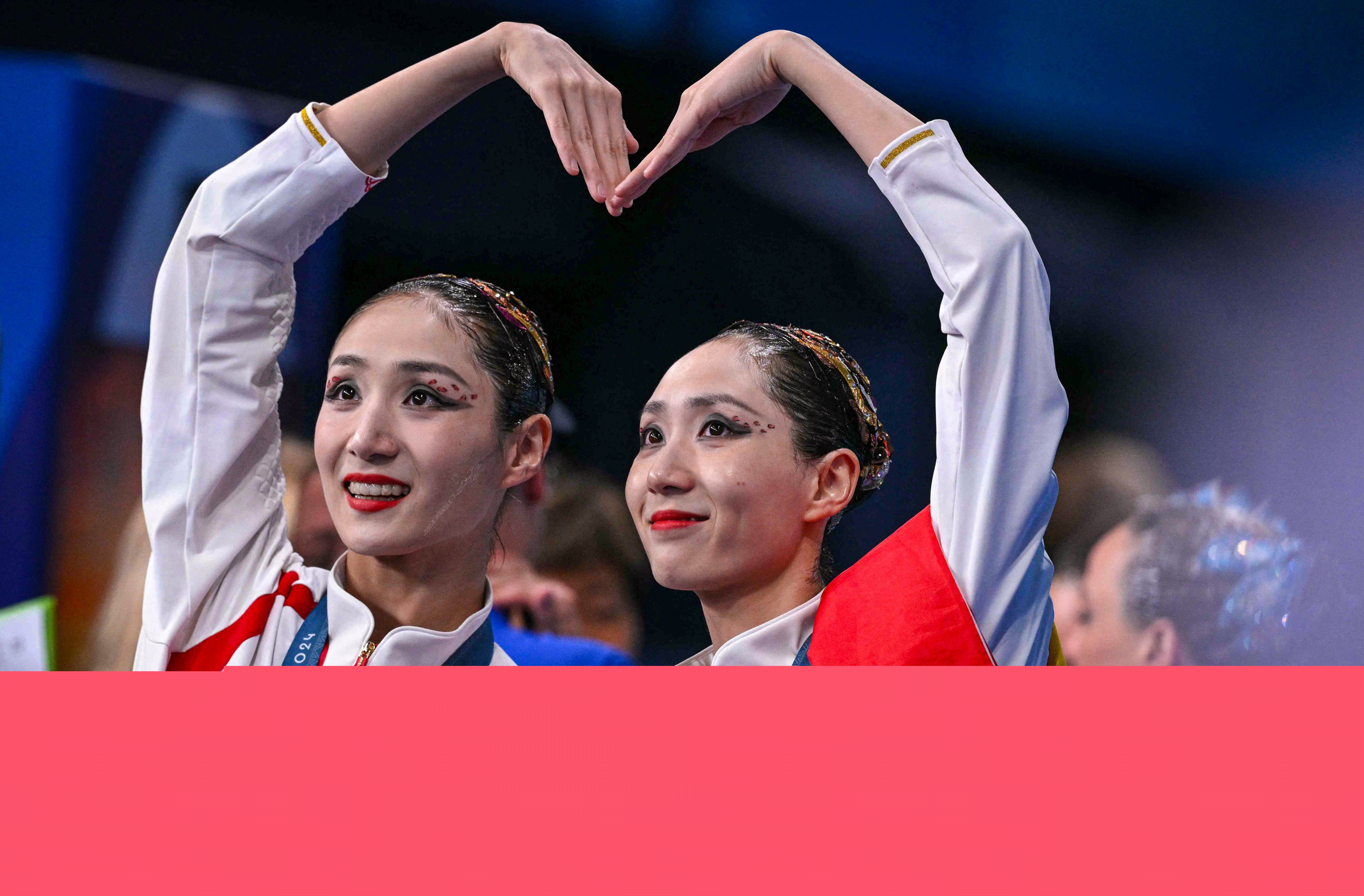 Gold medallists Wang Liuyi and Wang Qianyi celebrate after securing gold in Paris. Photo: AFP